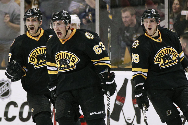 Brad Marchand has plenty to shout about after scoring against the New Jersey Devils Tuesday night in Boston. The Bruins scored late in the third period for a 4-3 win.