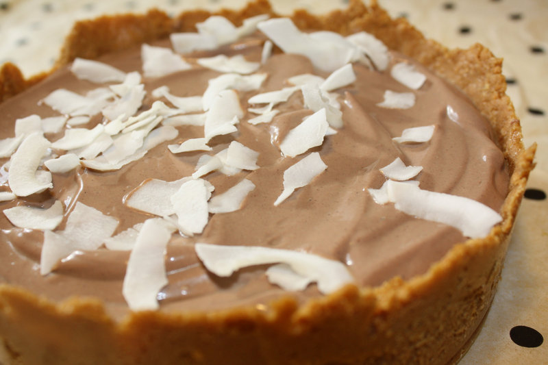 Chocolate Pudding Pie in a graham cracker crust can be topped with coconut flakes.