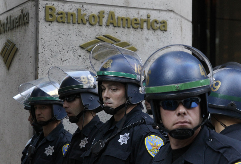 San Francisco police wait outside a Bank of America branch after more than 100 protesters stormed into the office on Wednesday. Police arrested a number of protesters.