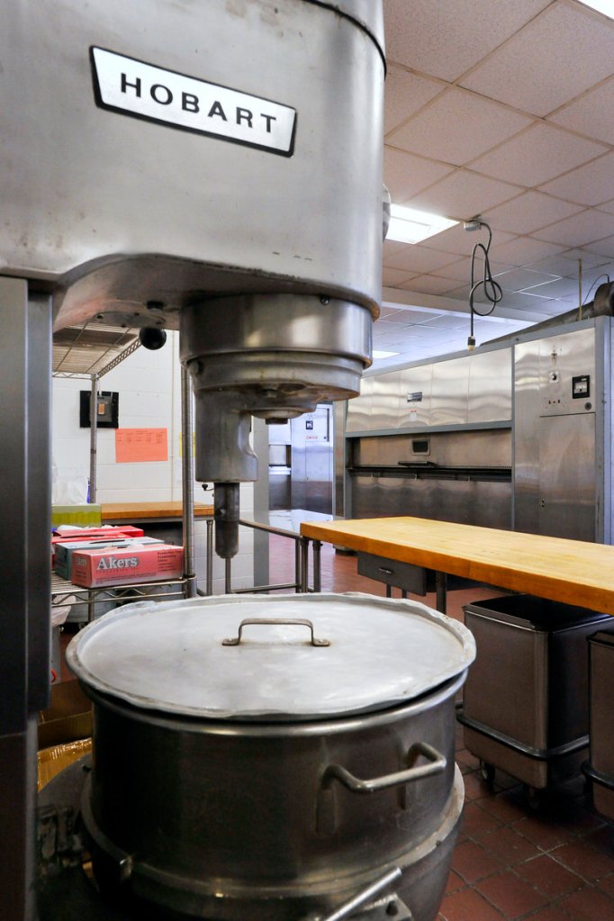 Three commercial mixers and ovens are in the cook's room at the central kitchen.