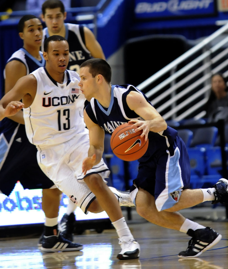 Maine guard Andrew Rogers drives against Connecticut’s Shabazz Napier during Thursday’s game in Hartford, Conn. Maine lost to the reigning NCAA champs, 80-60.