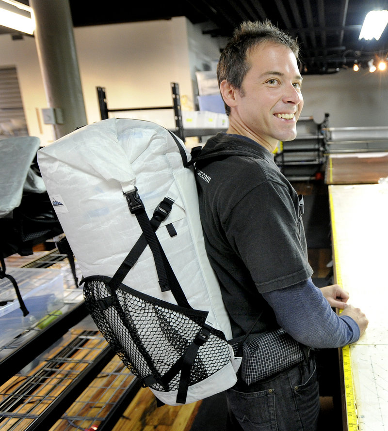 Mike St. Pierre, at his new business in Biddeford, models one of his backpacks.