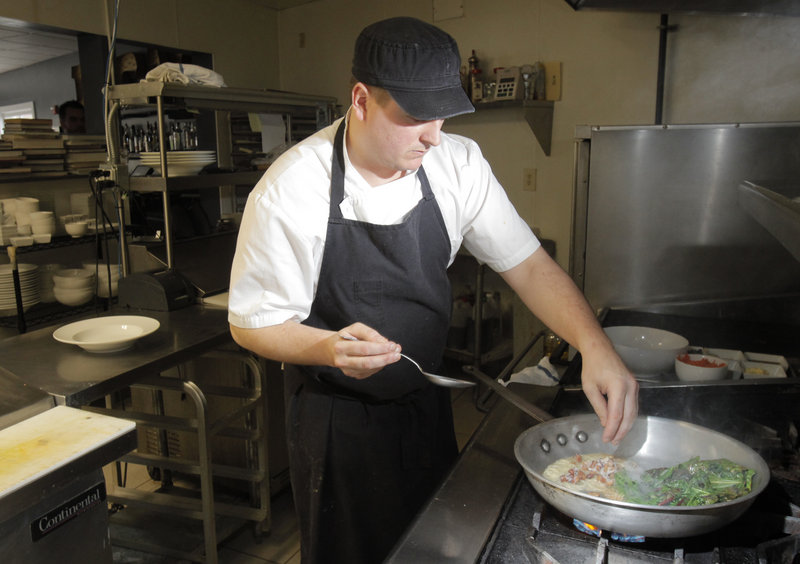 Chef David Ross of the restaurant 50 Local in Kennebunk prepares braised greens.