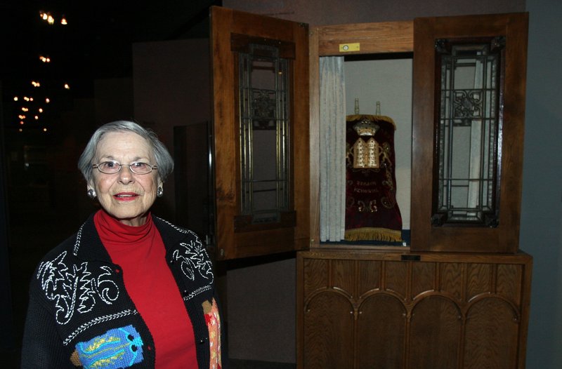 Miriam Freedman, a member of the Muskogee synagogue that closed, poses in front of an ark and Torah that were given to the Sherwin Miller Museum of Jewish Art along with other religious artifacts last month in Tulsa, Okla.