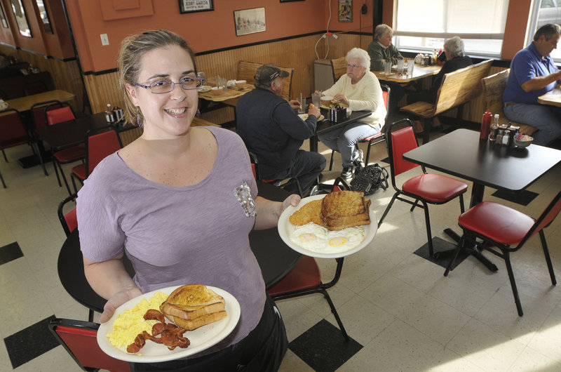 Andrea Thompson, a waitress at Q Street Diner in South Portland, serves breakfast to her customers.