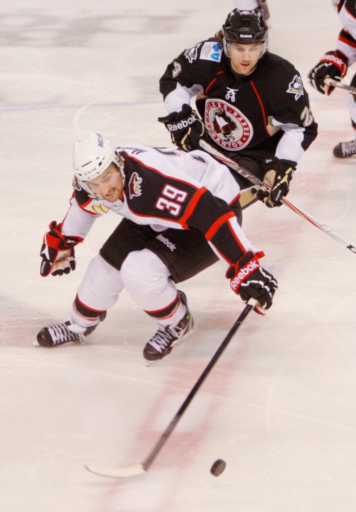 Brett MacLean of the Portland Pirates chases the puck Friday night ahead of Brandon DeFazio of the Wilkes-Barre/Scranton Penguins.
