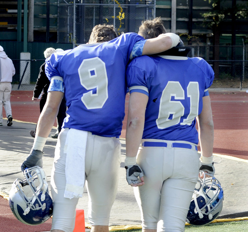 Win or lose, they're still teammates and friends. And that's how it was Saturday for Spencer Carey, left, and Josh Perry of Lawrence following a 49-7 loss to Cheverus in the Class A final.