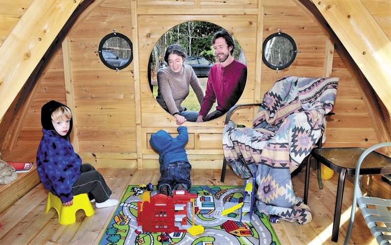 Melissa and Rocy Pillsbury watch as their children Richard, left, and Maxximus play in one of the Hobbit Hole playhouses they make for their Unity business, Wooden Wonders. The structures are variations of those described in J.R.R. Tolkien’s novels.