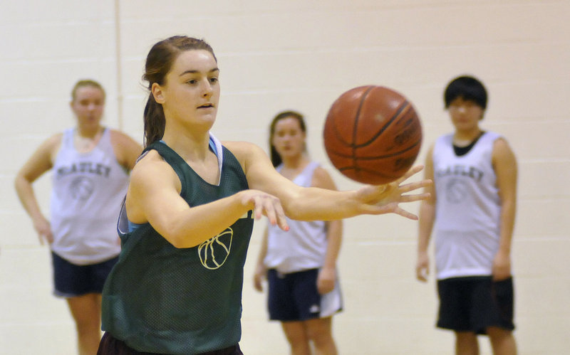 Allie Clement of McAuley passes to a teammate during Monday’s first practice of the season.