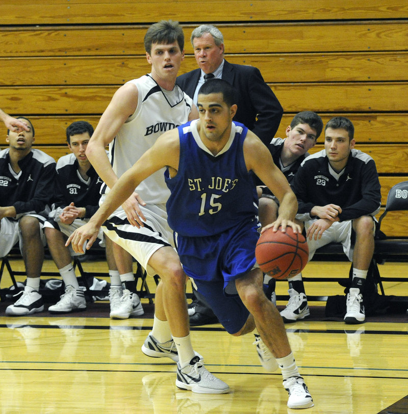 Zach O Brien of St. Joseph's looks for room along the baseline while pursued by Will Hanley of Bowdoin.