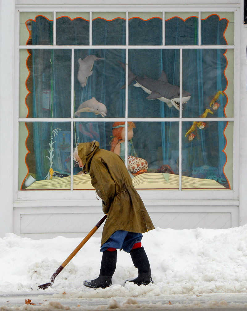 Eighty-six-year-old Jane Bryant shovels snow in front of her home on Route 5 in Limerick on Wednesday.