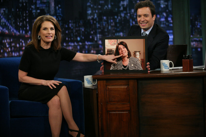 Michele Bachmann, in this NBC photo, points to a photo of Jimmy Fallon dressed as Bachmann, during her visit to “Late Night with Jimmy Fallon” Tuesday.