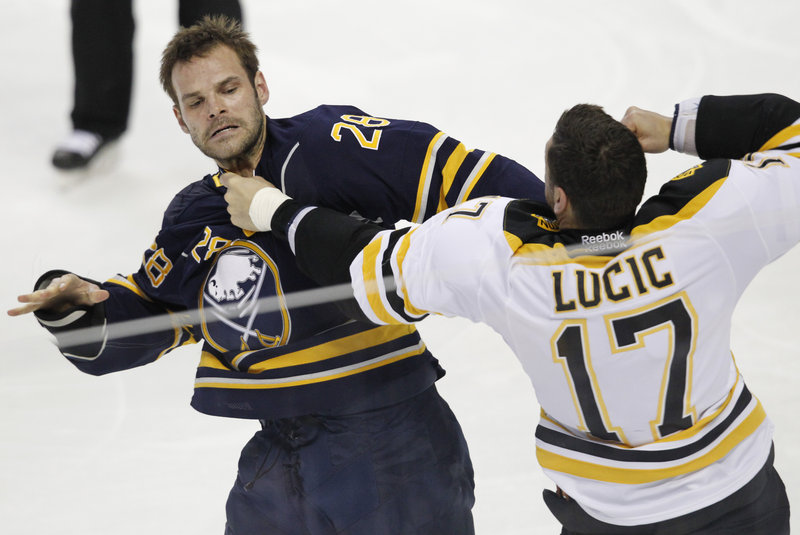 Milan Lucic of the Boston Bruins squares off with Paul Gaustad of the Buffalo Sabres in the first period of their game Wednesday night. The Bruins came away with a 4-3 victory in a shootout.