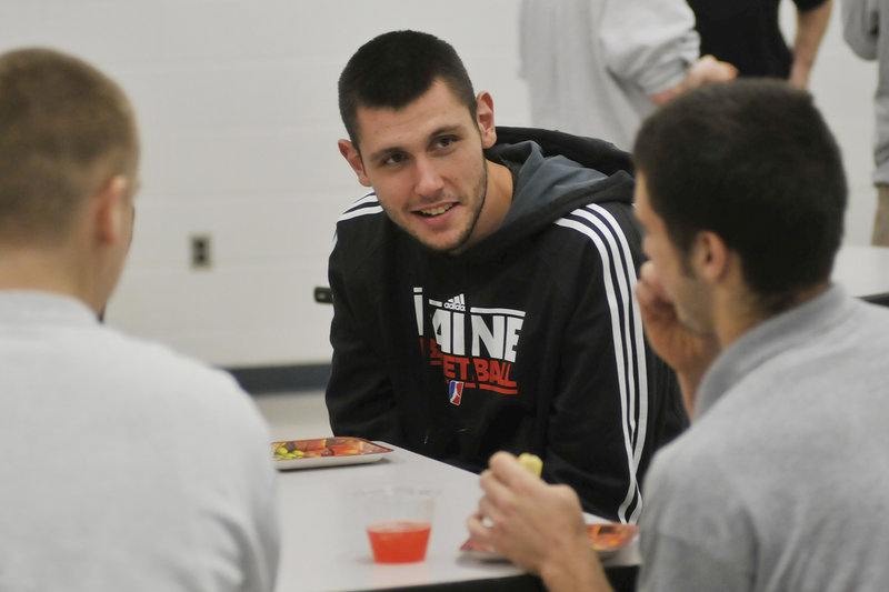 Mike Tisdale of the Red Claws talks with a youth center resident Thursday. One resident was amazed to learn that Tisdale wears a size-18 shoe. “It’s a freakin’ boat,” said Alex Pedroza.