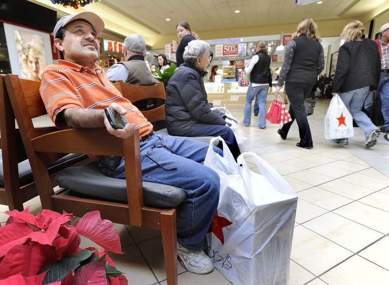 Kiam Hajizadeh of Falmouth, whose family started shopping at 6 a.m. Friday, waits for his wife and their two children at the Maine Mall. "I still have a long way to go," he said.