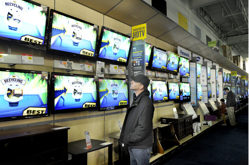 Jamie Morrisseau of Harrison checks out televisions at Best Buy on Friday. The store sold out of 42-inch Sharp LCD televisions for $199.99 before it even opened at midnight.