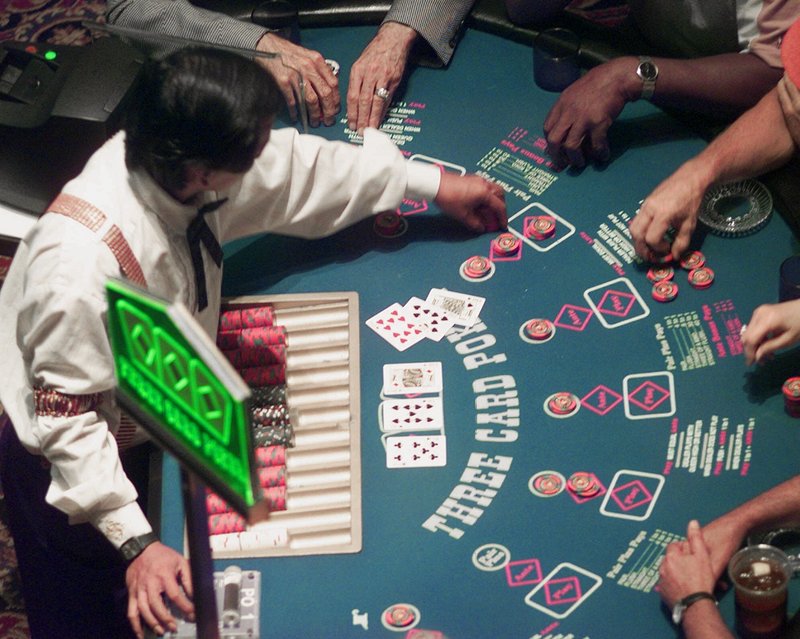 Poker players make wagers at Station Casino in Kansas City, Mo., in 1999. Gamblers will soon be able to place their bets on blackjack, craps and other table games in Maine when Hollywood Slots in Bangor adds 14 table games next spring. A casino under construction in Oxford also plans to have games when it opens in June.