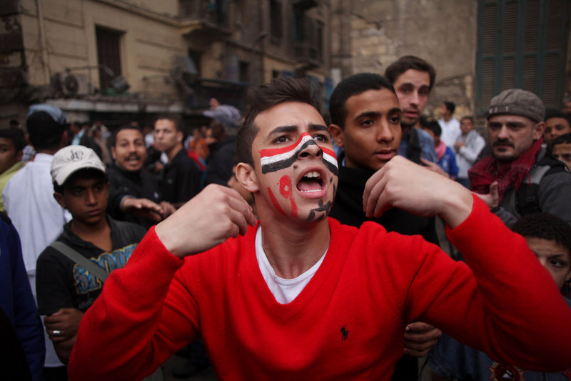 A protester with the colors of Egypt's flag on his face joins tens of thousands of others Friday near Tahrir Square in Cairo.
