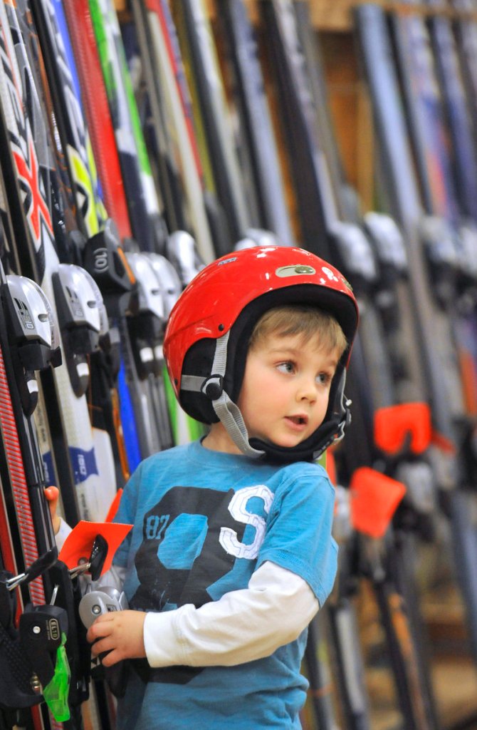 Jack Reagan, 4, of Falmouth checks out the ski selection while wearing a newly acquired ski helmet.
