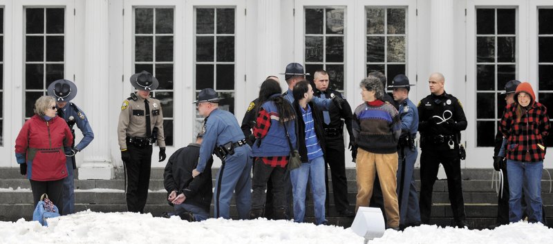Protesters are arrested Sunday on the lawn of the Blaine House during a rally by Occupy Augusta. Police said nine people were charged with criminal trespass and failure to disperse after refusing to leave the lawn of the governor's mansion.