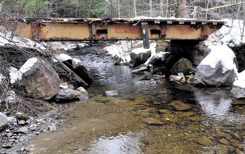 Roland Drew of Arundel died late Friday when his truck plunged off the side of this wooden snowmobile bridge.