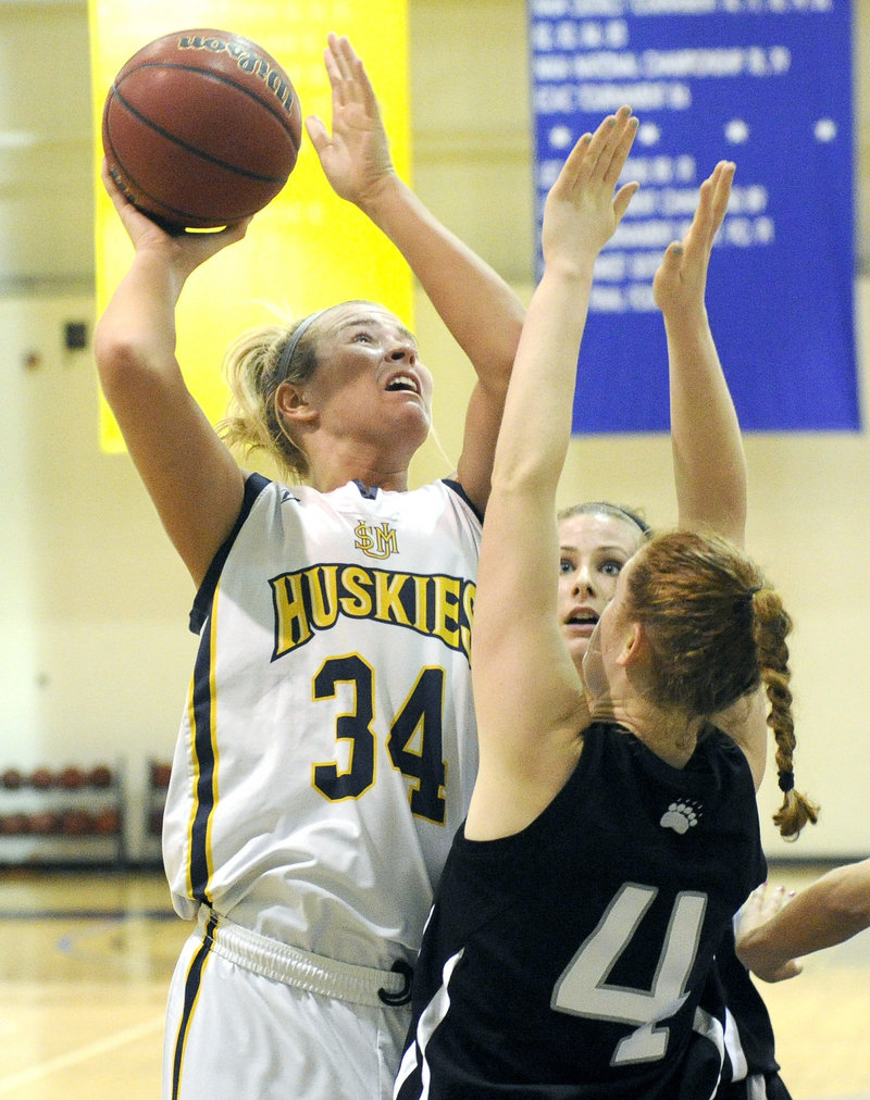 Courtney Cochran of USM finds room in the middle to shoot over Allie Piscina of Bowdoin. Cochran finished with 18 rebounds to help the Huskies come away with a 42-34 advantage on the boards.