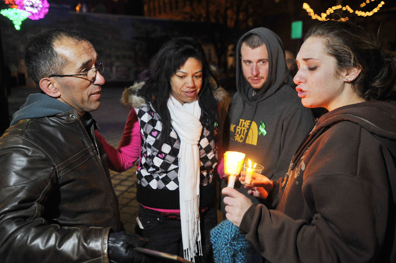 Trista Reynolds, right, is consoled by her father, Ronald Reynolds, left, and her stepsister, Whitney Raynor of Portland, second from left, and her fiancee, Charles Martin of Westbrook, at the conclusion of a Dec. 23 vigil for her missing 20-month-old daughter.