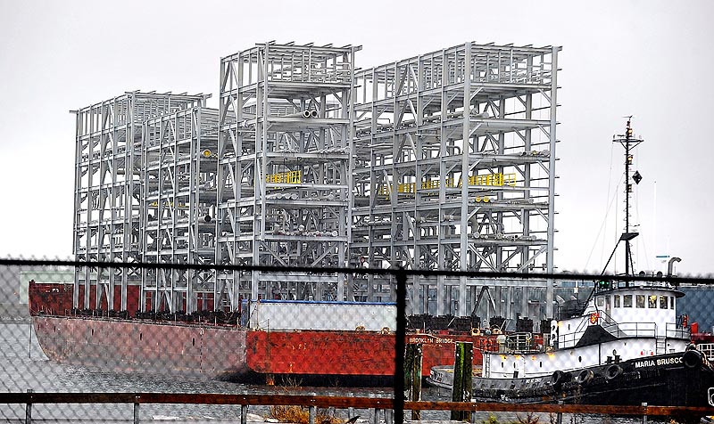 Gordon Chibroski / Staff Photographer. Wednesday, Dec. 7, 2011. This eight-story-tall metal structure aboard a barge is part of a processing plant headed to Newfoundland. It came to Portland to avoid rough weather at sea.