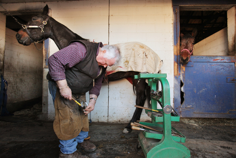 Ernie Lowell shoes a horse at Scarborough Downs last week. The farrier has served Scarborough Downs for 43 years.