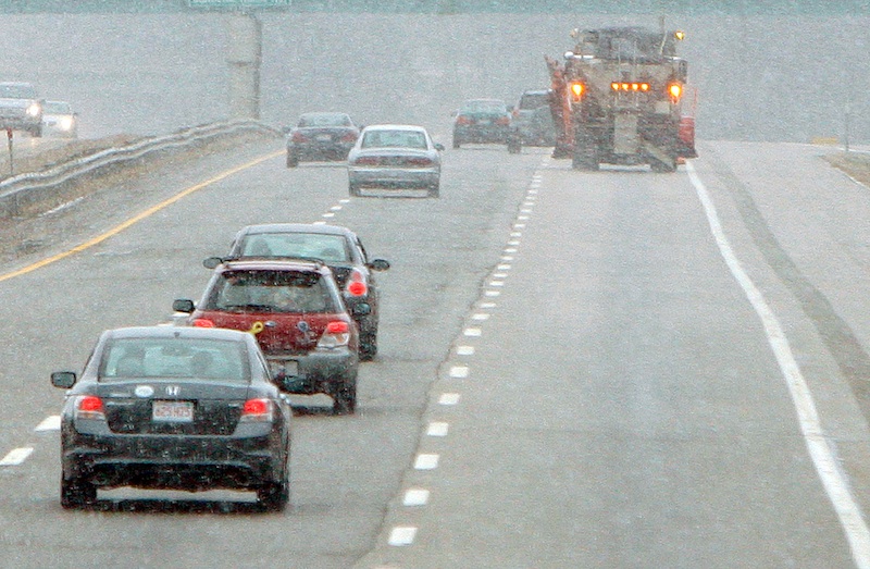 Gregory Rec/Staff Photographer: In a heavy snow squall, a plow truck patrols the northbound lane of the Maine Turnpike in Biddeford on Saturday. Snow and freezing temperatures made roads icy on Saturday morning sending cars off roads and causing numerous fender benders.