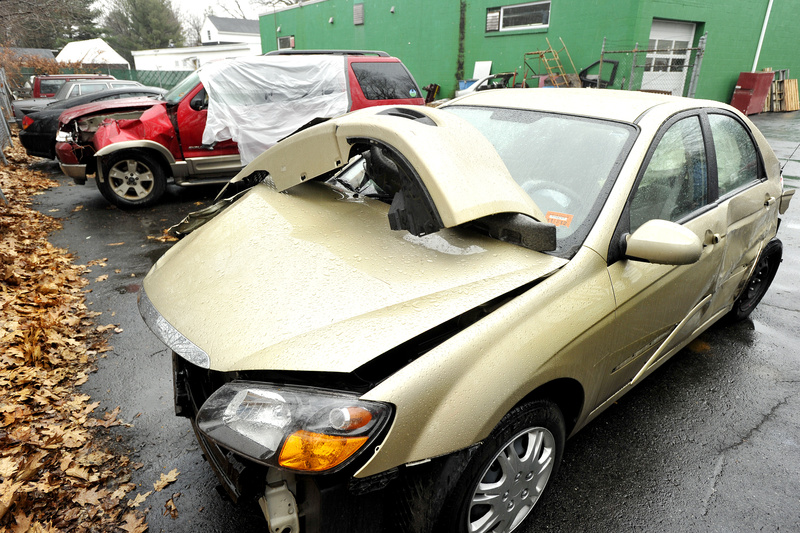 Vehicles taken to Acme Body Shop on Lincoln Street in South Portland exhibit the damage sustained in crashes that resulted from icy conditions Wednesday morning in southern Maine.