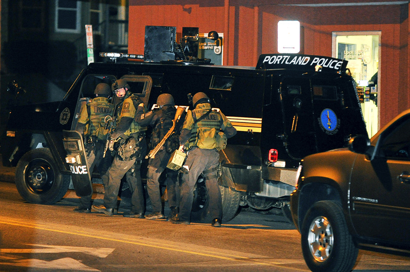 Portland police move toward the St. John Street apartment building where Patrick Mullen. The standoff required the efforts of police department's special reaction team and hostage crisis negotiators, The Southern Maine Tactical Team, comprising officers from South Portland, Scarborough and Cape Elizabeth, joined the effort in the early morning hours.