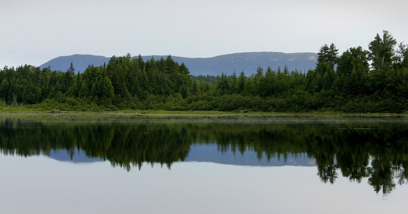 Big Spencer Mountain is reflected in Second Roach Pond, located in Maine's 100-mile Wilderness. Maine's north woods is the largest contiguous forest in the Northeast, and it's an area where many competing interests must be considered. northern exposure series