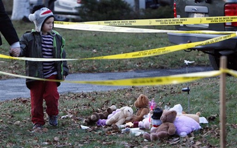 Isaiah Vear, 5, of Waterville, leaves a memorial after placing a toy for missing 20-month-old Ayla Reynolds outside the toddler's home, Thursday, Dec. 22, 2011. Investigators put up crime scene tape around the house on Thursday. (AP Photo/Robert F. Bukaty)