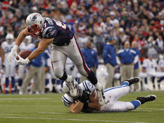 Patriots tight end Rob Gronkowski (87) flies over Colts linebacker A.J. Edds (52) during the second half of in Foxborough, Mass., this afternoon.