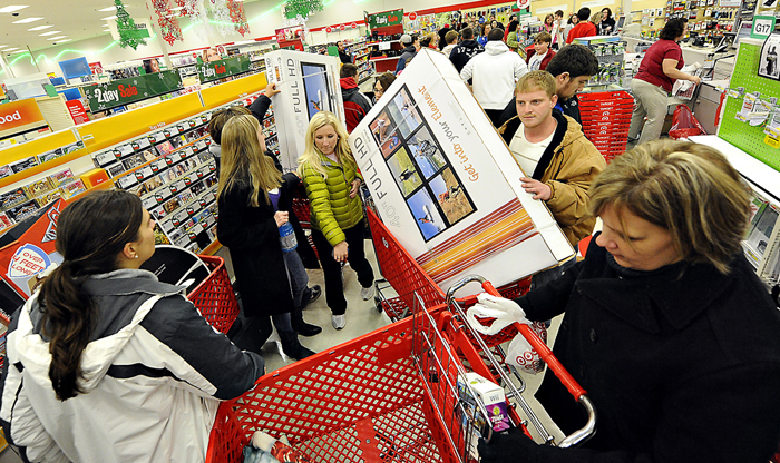 Shoppers scramble for door buster deals at Target, in Bowling Green, Ky., recently. U.S. consumers spent at a lackluster rate in November as their incomes barely grew.