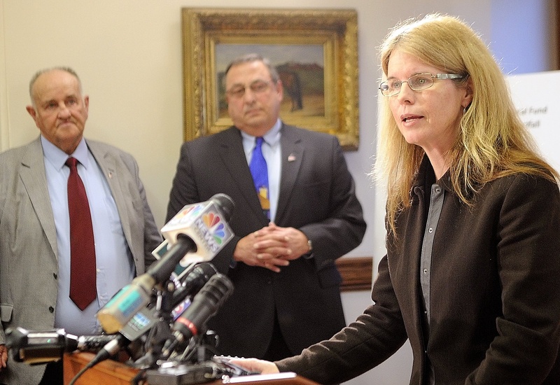 Mary Mayhew, the commissioner of the Department of Health & Human Services, right, said her team has been analyzing Medicaid numbers for months. Shown at left are H. Sawin Millett Jr., the commissioner of Administrative & Financial Services, and Gov. Paul LePage, during a news conference last week.