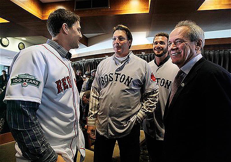 Boston Red Sox baseball president and CEO Larry Lucchino, far right, talks with catcher Ryan Lavarnway, left, hitting coach Dave Magadan, center, and catcher Jarrod Saltalamacchia at a news conference at Fenway Park in Boston on Thursday, Dec. 8, 2011. Red Sox players' uniforms for the 2012 season display a patch on the sleeves to commemorate the 100th anniversary of Fenway Park, the oldest operating Major League Baseball park in the United States. (AP Photo/Elise Amendola)