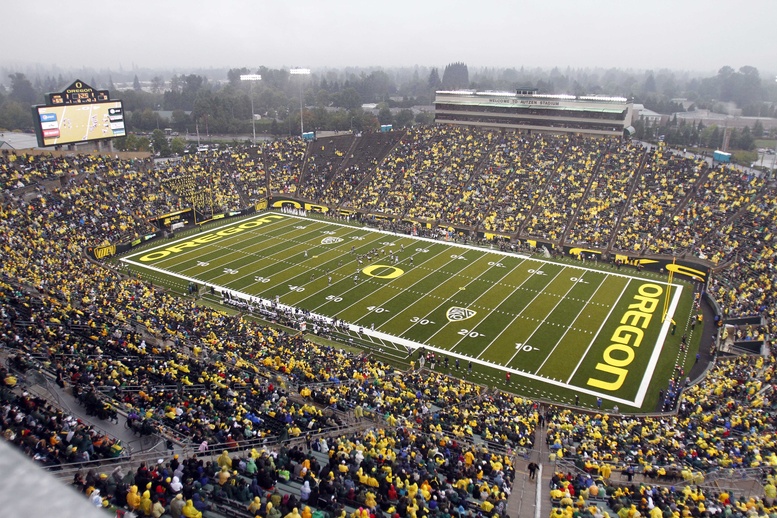 Spectators fill the University of Oregon's Autzen Stadium during an NCAA college football game. When the college football team was racking up wins on the field, the men in classrooms partied so hard their grades took a dive, a study finds.