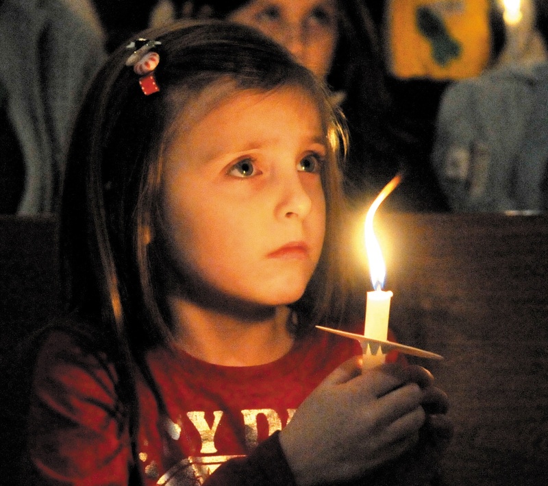 Katy Taylor, 5, joins in a vigil at the First Congregational Church in Waterville on Wednesday night for 20-month-old Ayla Reynolds, who was last seen Friday night and remains missing.