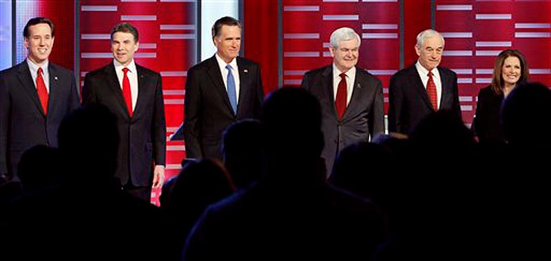 Republican presidential candidates, from left, former Pennsylvania Sen. Rick Santorum, Texas Gov. Rick Perry, former Massachusetts Gov. Mitt Romney, former Speaker of the House Newt Gingrich, Rep. Ron Paul, R-Texas, and Rep. Michele Bachmann, R-Minn, stand together prior to their Republican debate, Saturday, Dec. 10, 2011, in Des Moines, Iowa. (AP Photo/Eric Gay)