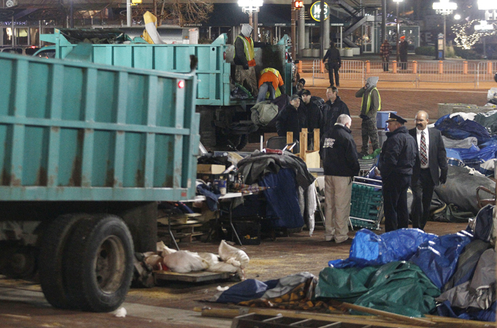 Sanitation workers remove debris from McKeldin Square in Baltimore after police evicted Occupy protesters this morning.