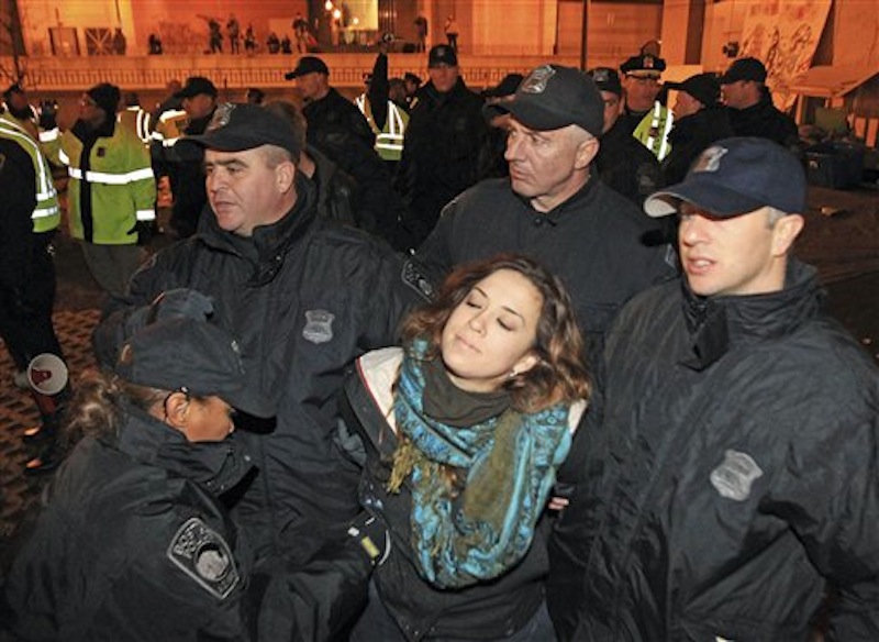 Boston police officers remove an Occupy Boston protester from Dewey Square in Boston before dawn Saturday, Dec. 10, 2011. More than 40 people were peacefully arrested as the park was cleared. The city had set a Thursday midnight deadline for protesters to leave or face eviction. (AP Photo/The Boston Globe, Essdras M Suarez, , Pool)