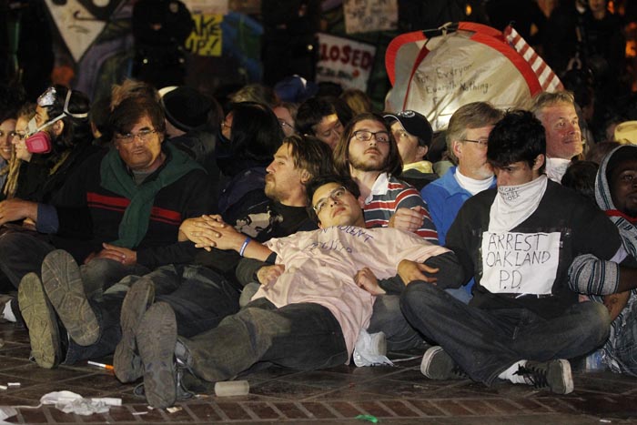Protesters wait to be arrested as Los Angeles police begin clearing the Occupy LA encampment outside City Hall in Los Angeles on Wednesday.
