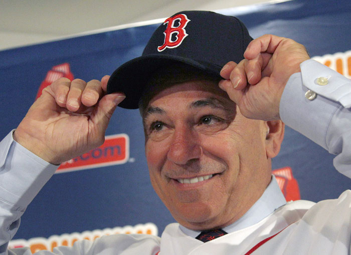 Boston Red Sox manager Bobby Valentine puts on a cap during a news conference at Fenway Park in Boston on Thursday. The 61-year-old former Rangers and Mets skipper is the 45th manager of the Red Sox.