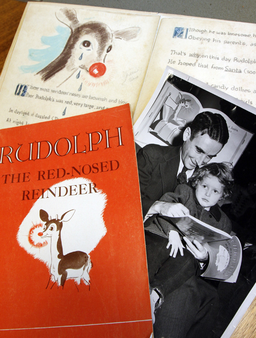 A first edition of "Rudolph, the Red-Nosed Reindeer," left, a photo of Robert May with his daughter, Barbara, right, and an original layout.