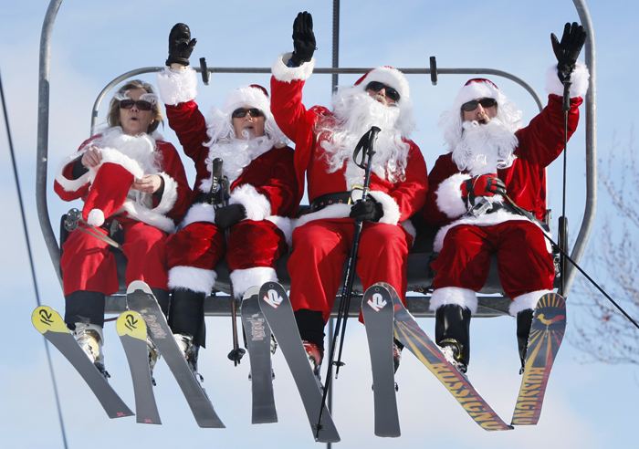 Some of the 250 Santas participating in a fundraiser today ride the chairlift at Sunday River Ski Resort in Newry.