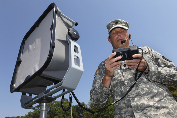 Lt. Col. Jeffrey Bevington, an officer with the Joint Non-Lethal Weapons Directorate, demonstrates one of the military's latest voice projection systems that can project a human voice a mile away and instantly translate from English to another language.