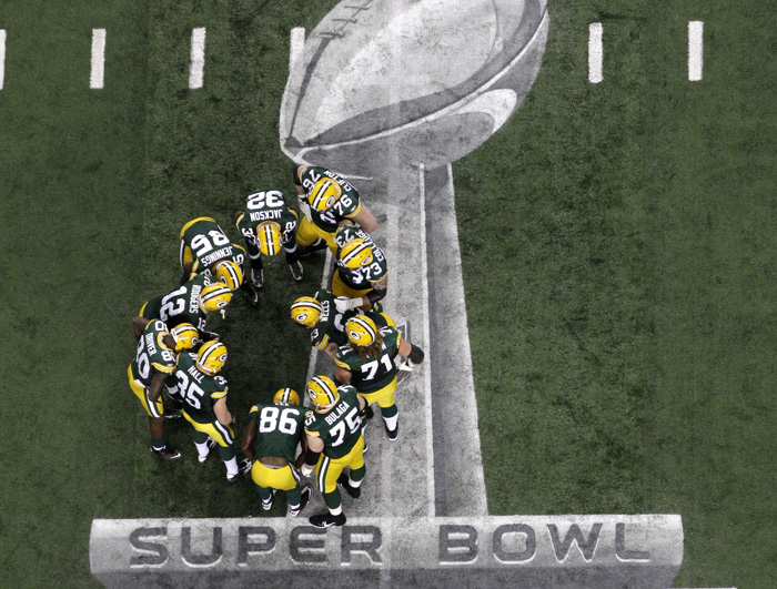 The Green Bay Packers gather on the field before the NFL Super Bowl XLV football game against the Pittsburgh Steelers on Feb. 6, 2011.