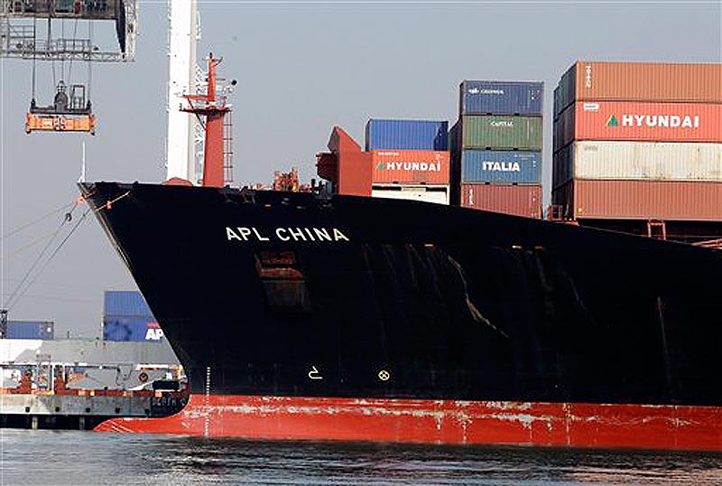 In this Dec. 8, 2011 photo, a container ship is docked at the Port of Oakland in Oakland, Calif. The U.S. trade deficit narrowed in October to its lowest point of the year as Americans bought fewer foreign cars and imported less oil. Exports of American-made autos also fell. (AP Photo/Paul Sakuma)